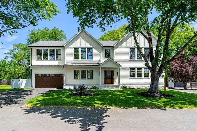 30 Alberta Ave, Newburyport, MA 01950 - view of front of house featuring asphalt driveway, a garage, and board and batten siding