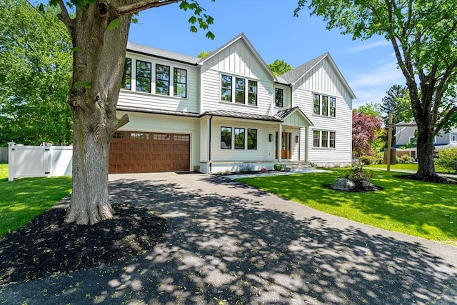 30 Alberta Ave, Newburyport, MA 01950 - view of front of house featuring an attached garage, board and batten siding, asphalt driveway, a standing seam roof, and metal roof