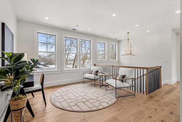 30 Alberta Ave, Newburyport, MA 01950 - sitting room featuring light wood-style flooring, a chandelier, recessed lighting, baseboards, and an upstairs landing