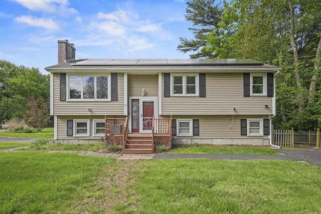 24 Highland Ave, Millbury, MA 01527 - bi-level home with a chimney and roof mounted solar panels