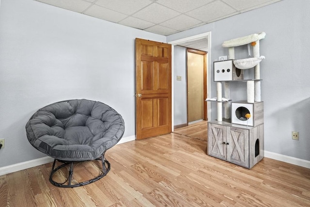 24 Highland Ave, Millbury, MA 01527 - sitting room with wood finished floors, baseboards, and a drop ceiling