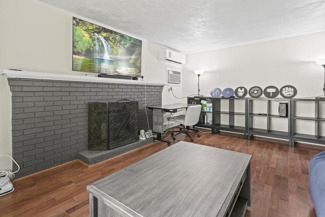 24 Highland Ave, Millbury, MA 01527 - living room featuring a wall mounted air conditioner, a fireplace, a wall unit AC, and wood finished floors