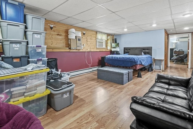 24 Highland Ave, Millbury, MA 01527 - bedroom featuring baseboard heating, wood finished floors, a drop ceiling, and a wall mounted air conditioner