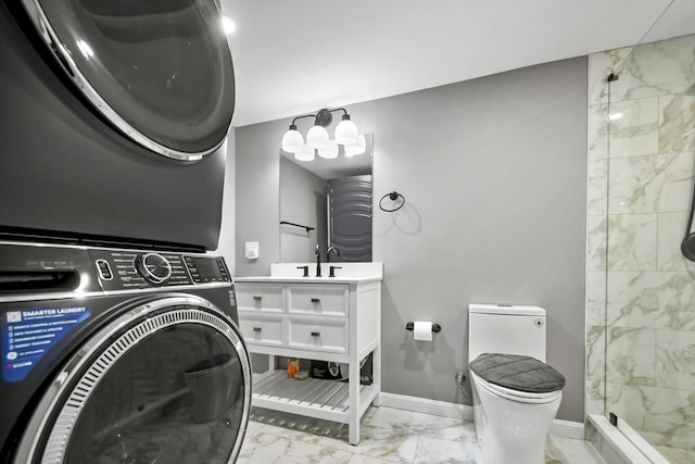 24 Highland Ave, Millbury, MA 01527 - full bath with marble finish flooring, estacked washer and dryer, toilet, baseboards, and vanity
