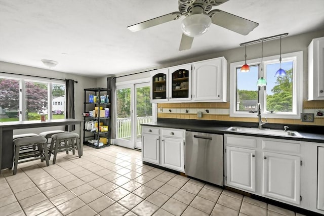 24 Highland Ave, Millbury, MA 01527 - kitchen with a sink, stainless steel dishwasher, dark countertops, backsplash, and white cabinets