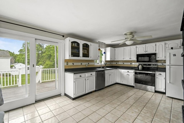 24 Highland Ave, Millbury, MA 01527 - kitchen featuring appliances with stainless steel finishes, dark countertops, a sink, and light tile patterned floors