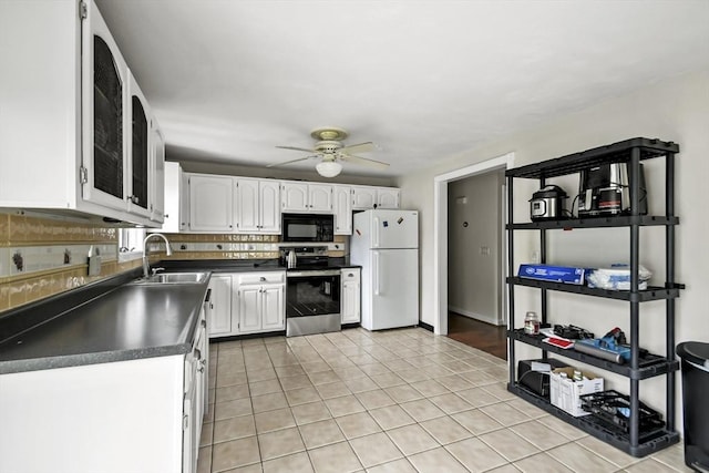 24 Highland Ave, Millbury, MA 01527 - kitchen with stainless steel electric stove, freestanding refrigerator, black microwave, a sink, and dark countertops