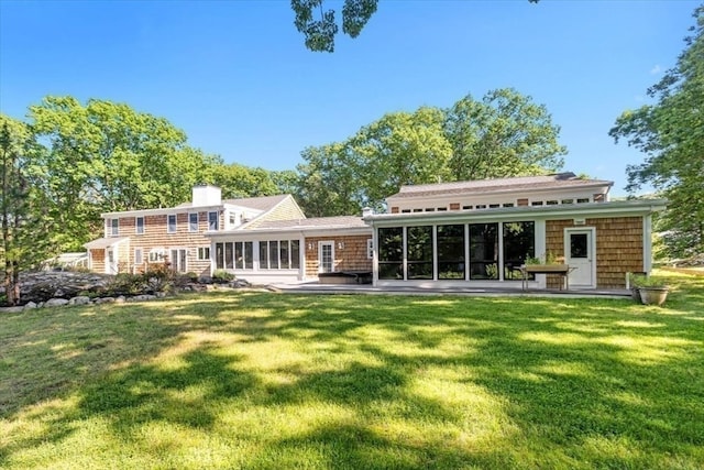 rear view of property with a patio and a yard