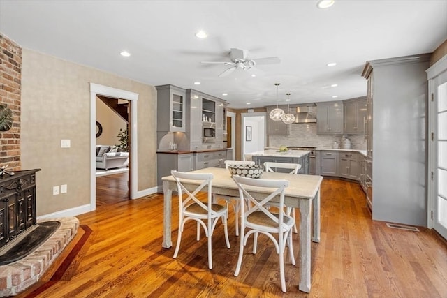 dining area featuring ceiling fan and light hardwood / wood-style flooring