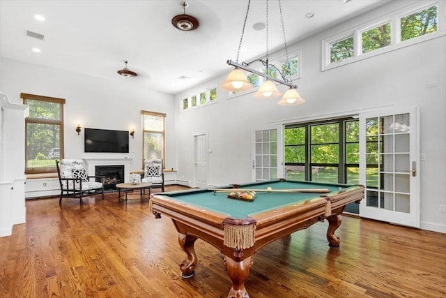 playroom featuring pool table, wood-type flooring, and a high ceiling