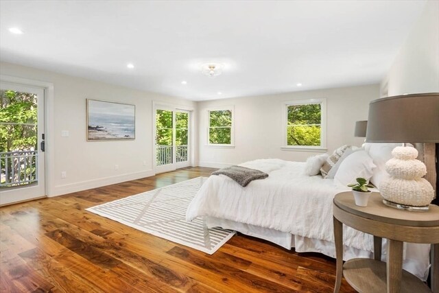 bedroom featuring access to exterior and wood-type flooring