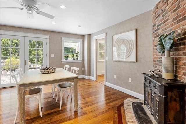8 Evergreen Ln, Hingham, MA 02043 - dining space with wood finished floors, baseboards, ceiling fan, french doors, and a wood stove