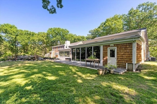 8 Evergreen Ln, Hingham, MA 02043 - rear view of house with a lawn, central AC unit, a patio, and a chimney