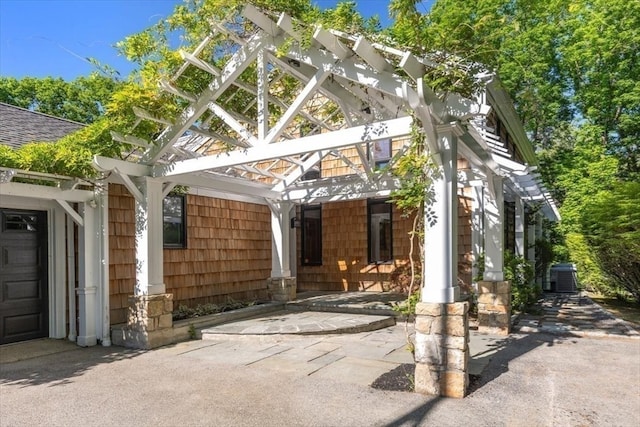 exterior space with central air condition unit and a garage