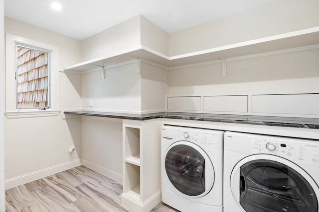 washroom featuring light hardwood / wood-style floors and washer and dryer