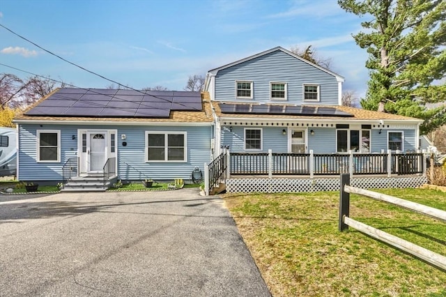 55 Friendship St, Billerica, MA 01821 - view of front of property with a shingled roof, a front yard, and solar panels