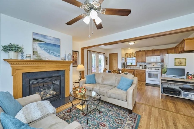 55 Friendship St, Billerica, MA 01821 - living room with a glass covered fireplace, ceiling fan, french doors, and light wood-type flooring