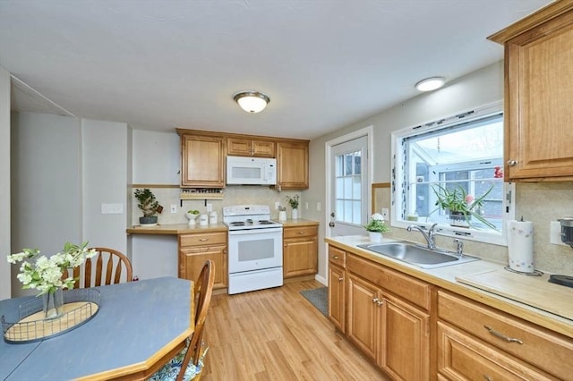 55 Friendship St, Billerica, MA 01821 - kitchen with light wood finished floors, light countertops, backsplash, a sink, and white appliances
