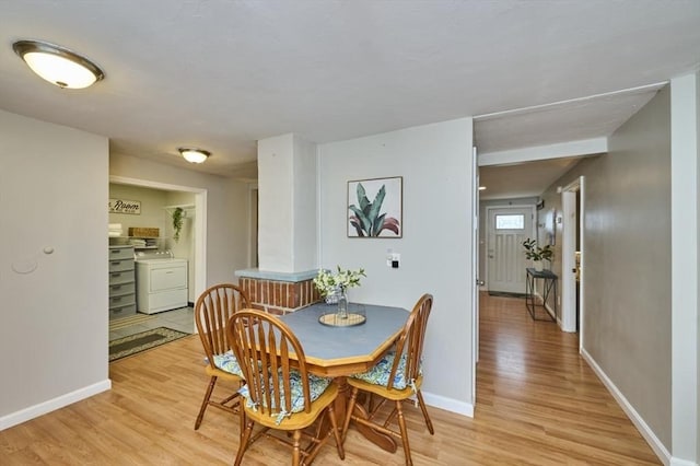 55 Friendship St, Billerica, MA 01821 - dining room featuring light wood finished floors, baseboards, and washer / clothes dryer