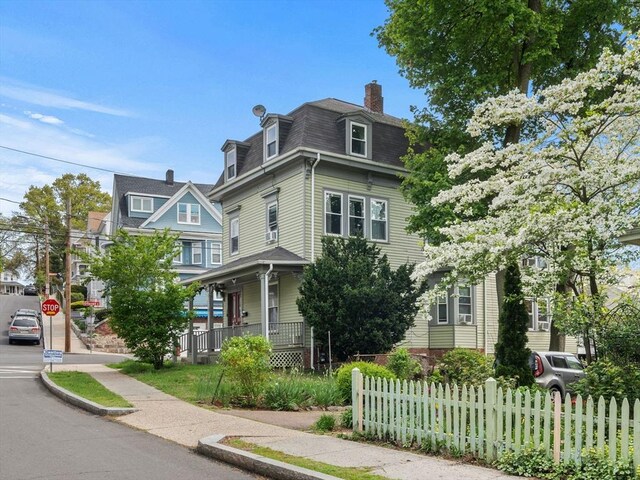 33 Franklin St, Chelsea, MA 02150 - victorian home with fence, mansard roof, a chimney, covered porch, and roof with shingles
