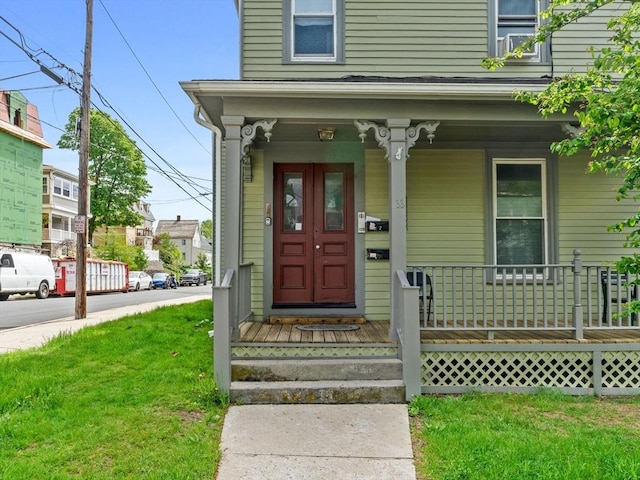 33 Franklin St, Chelsea, MA 02150 - view of exterior entry with a yard and a porch