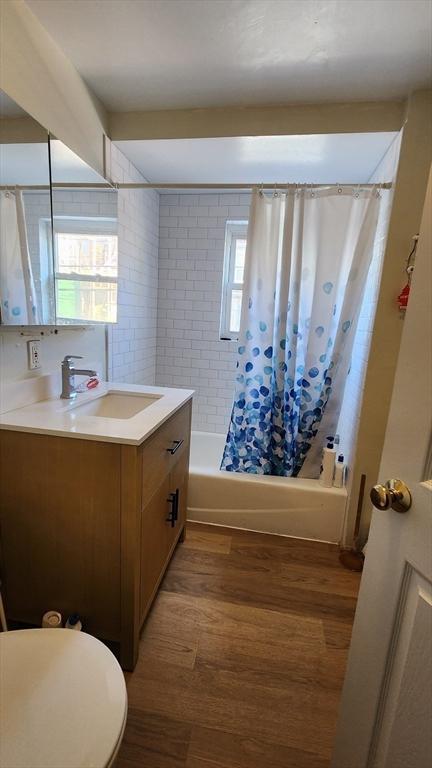 33 Franklin St, Chelsea, MA 02150 - bathroom with vanity, shower / bath combo with shower curtain, and wood finished floors