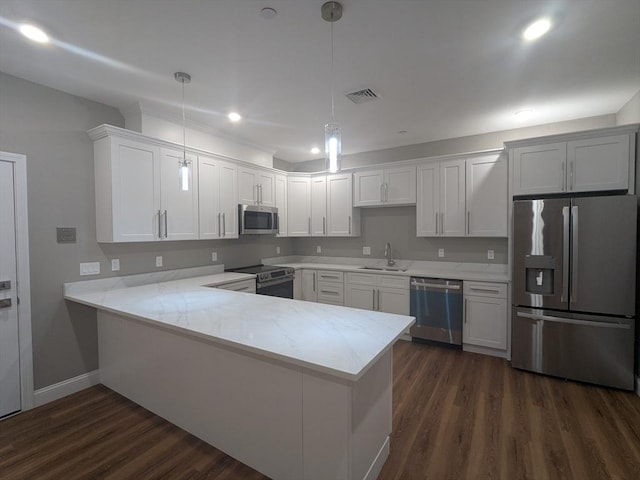 13 Nahant St Unit 2B, Lynn, MA 01902 - kitchen with stainless steel appliances, a sink, a peninsula, dark wood finished floors, and baseboards
