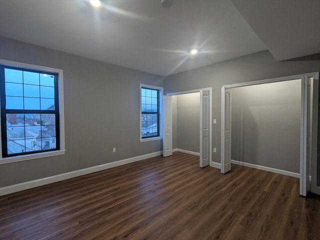 13 Nahant St Unit 2B, Lynn, MA 01902 - unfurnished bedroom with dark wood finished floors, baseboards, and two closets