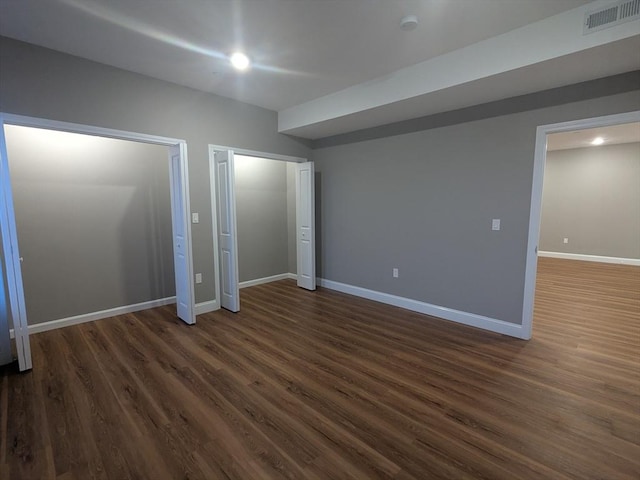 13 Nahant St Unit 2B, Lynn, MA 01902 - unfurnished bedroom with dark wood-style flooring, multiple closets, and baseboards