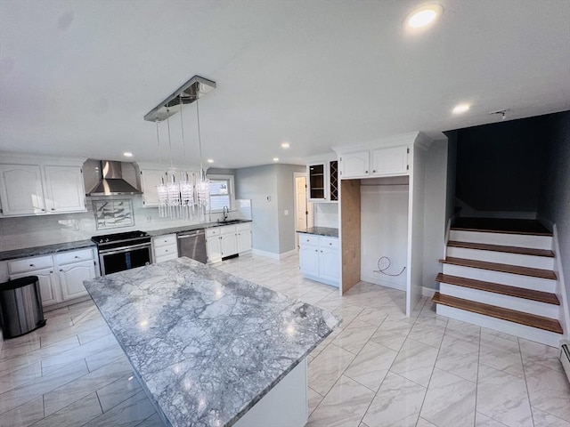 kitchen with marble finish floor, wall chimney exhaust hood, appliances with stainless steel finishes, and tasteful backsplash