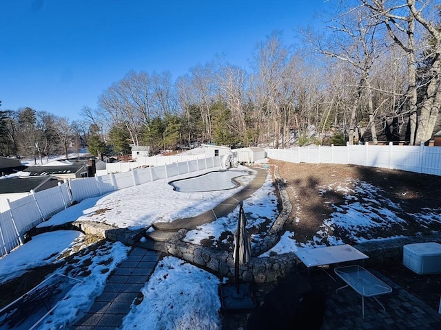 yard layered in snow featuring a fenced backyard