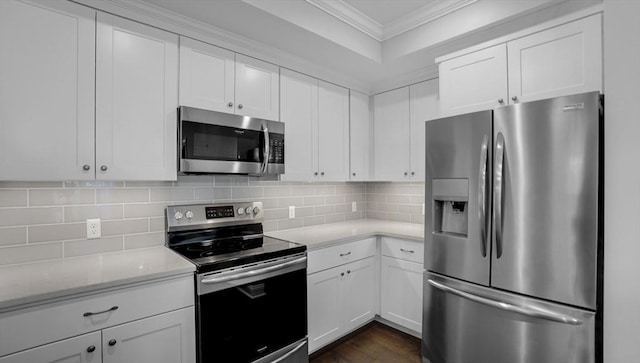 635 Old Post Rd Unit 204, Sharon, MA 02067 - kitchen with appliances with stainless steel finishes, ornamental molding, white cabinetry, decorative backsplash, and dark wood finished floors