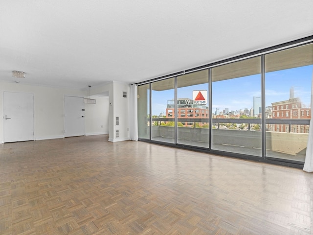 unfurnished room featuring floor to ceiling windows and parquet floors