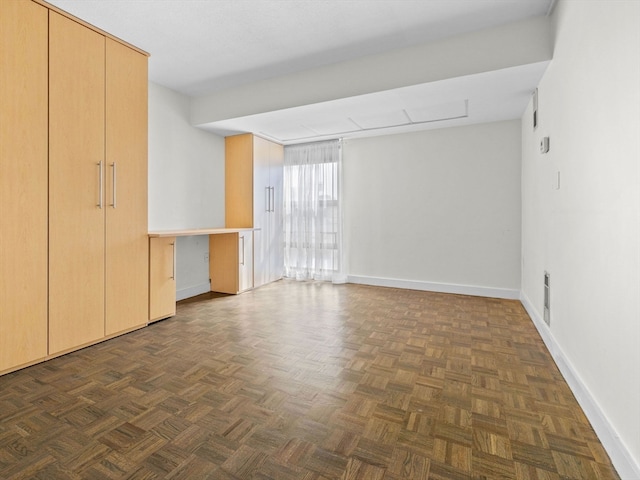 unfurnished room with dark parquet flooring