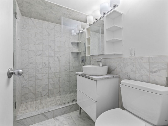 bathroom with tile walls, walk in shower, vanity, and toilet