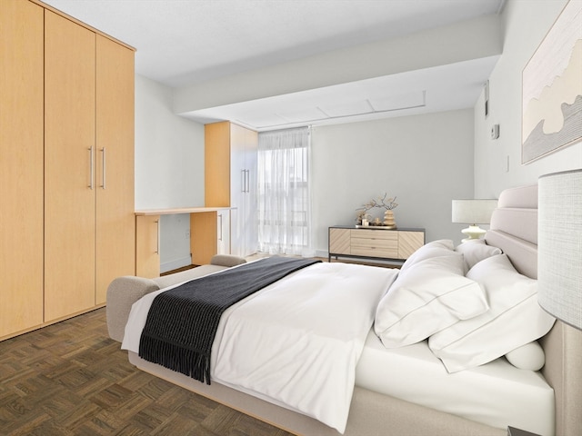 bedroom with a closet and dark parquet flooring