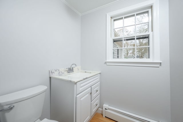 bathroom with vanity, toilet, baseboard heating, and crown molding