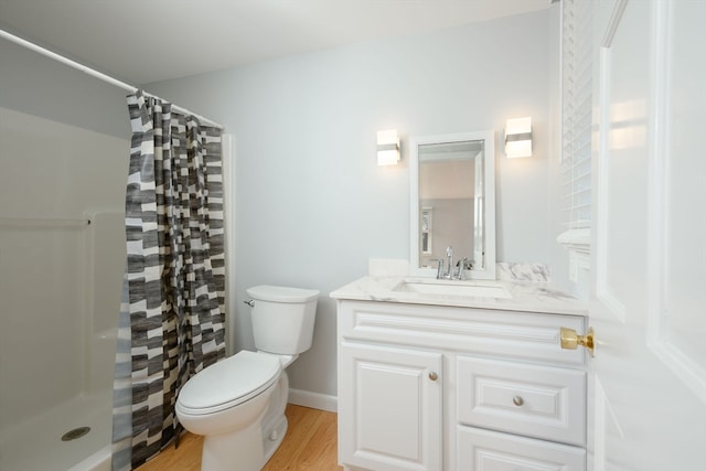 bathroom featuring hardwood / wood-style flooring, vanity, toilet, and a shower with shower curtain