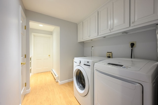 laundry room featuring independent washer and dryer, cabinets, light wood-type flooring, and baseboard heating