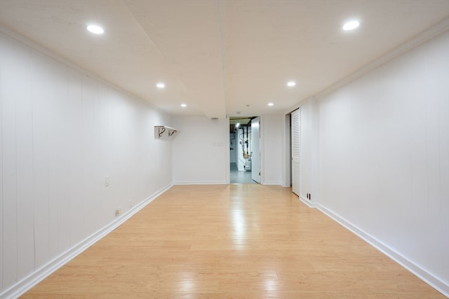 empty room with light hardwood / wood-style floors and ornamental molding