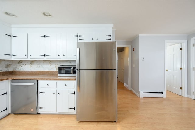 kitchen with tasteful backsplash, a baseboard heating unit, appliances with stainless steel finishes, white cabinets, and light wood-type flooring