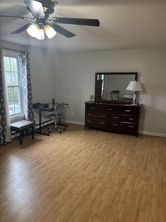 bedroom featuring light wood-type flooring, baseboards, and ceiling fan