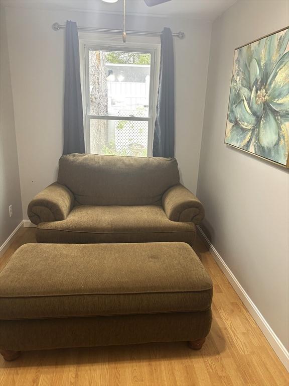 sitting room featuring light wood-style flooring and baseboards