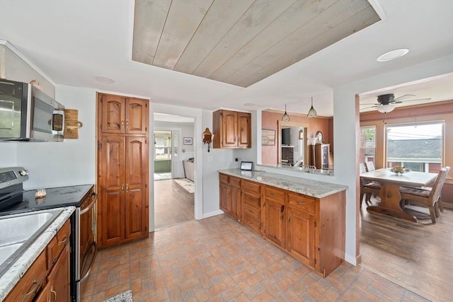 20 Harlem Rd, Weymouth, MA 02191 - kitchen with stainless steel appliances, brown cabinetry, baseboards, and ceiling fan