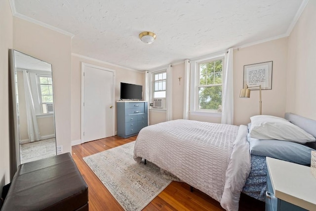 20 Harlem Rd, Weymouth, MA 02191 - bedroom featuring crown molding, light wood-style floors, multiple windows, a textured ceiling, and baseboards