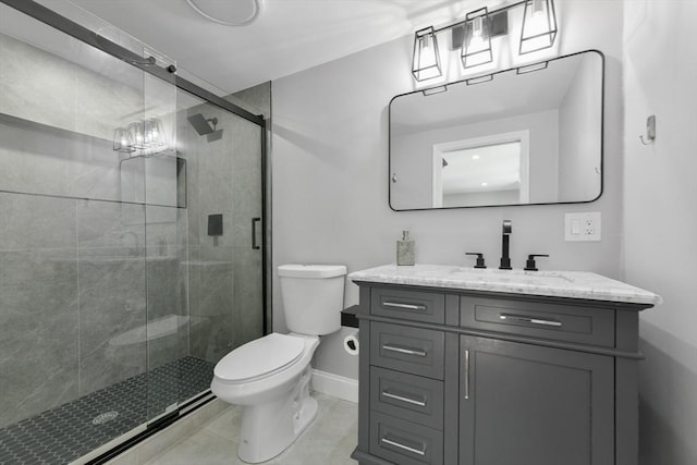 bathroom with a stall shower, baseboards, toilet, tile patterned flooring, and vanity