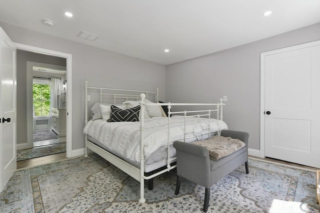 bedroom with recessed lighting, visible vents, baseboards, and wood finished floors