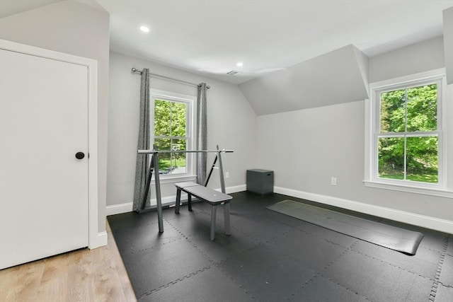 exercise area featuring lofted ceiling, light wood finished floors, recessed lighting, and baseboards