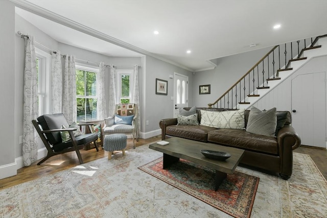 living room featuring crown molding, recessed lighting, wood finished floors, baseboards, and stairs