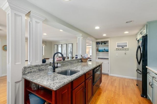 3 Centre St, Waltham, MA 02453 - kitchen with ornate columns, a sink, open shelves, light wood-type flooring, and freestanding refrigerator